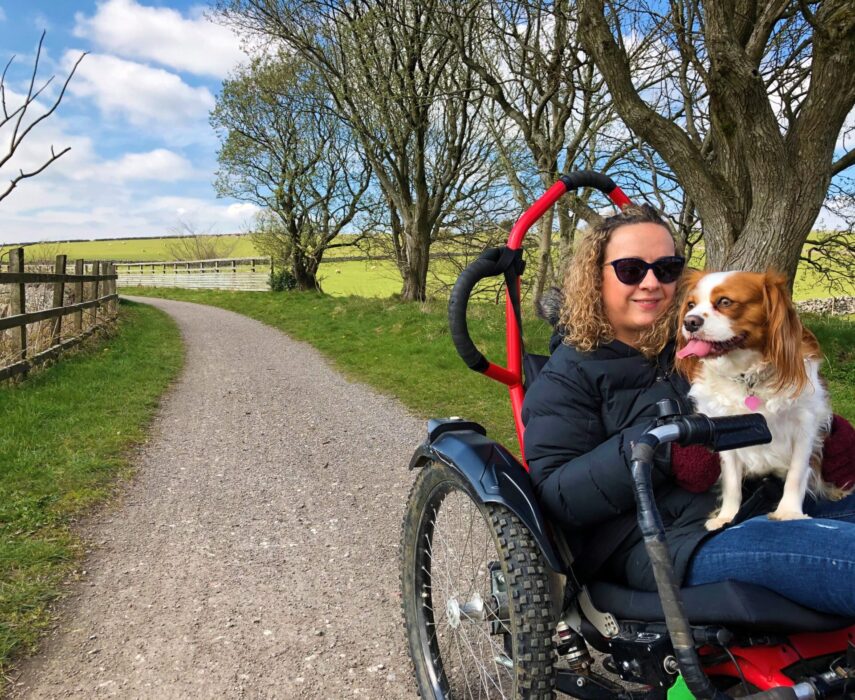 Travel blogger Carrie-Ann Lightley using the off-road wheelchair on trail with dog