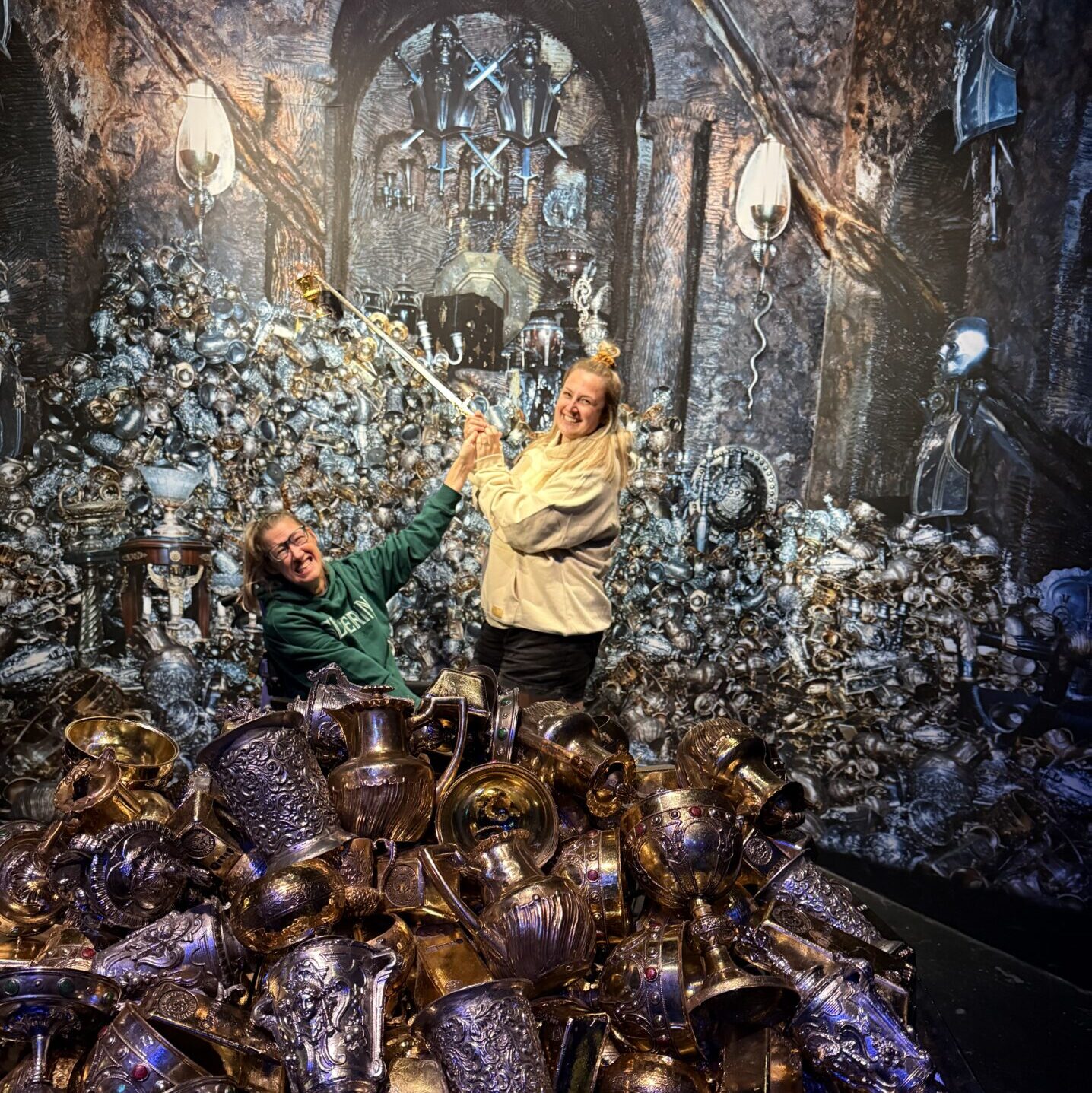 Hannah and Becky are pictured in a Gringotts vault amongst treasure and goblets. 