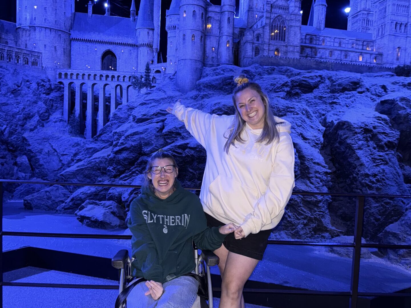 Hannah and Becky Cheetham at the Warner Bros. Studio Tour London -The Making of Harry Potter. They are pictured in front of the Hogwarts castle.