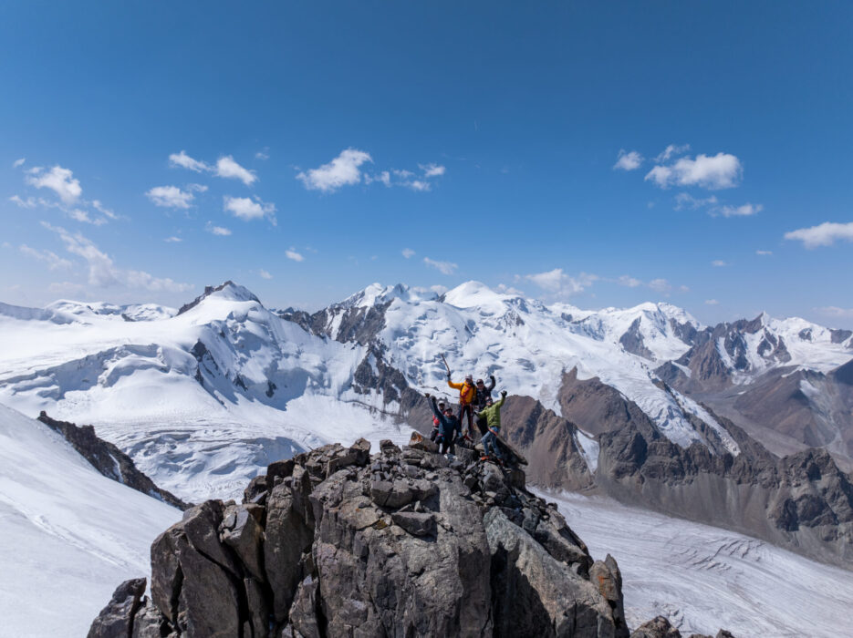 An image of Ed and the rest of his team on top of a mountain peak in Kyrgyzstan.