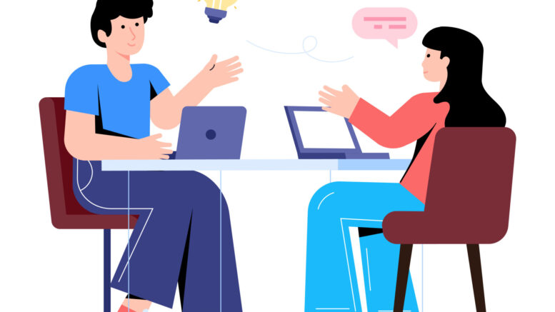 A cartoon graphic of a man and a woman discussing ideas while they work on laptops at a table. There is a lightbulb and a speech bubble element above their heads, representing ideas of discussion and understanding.